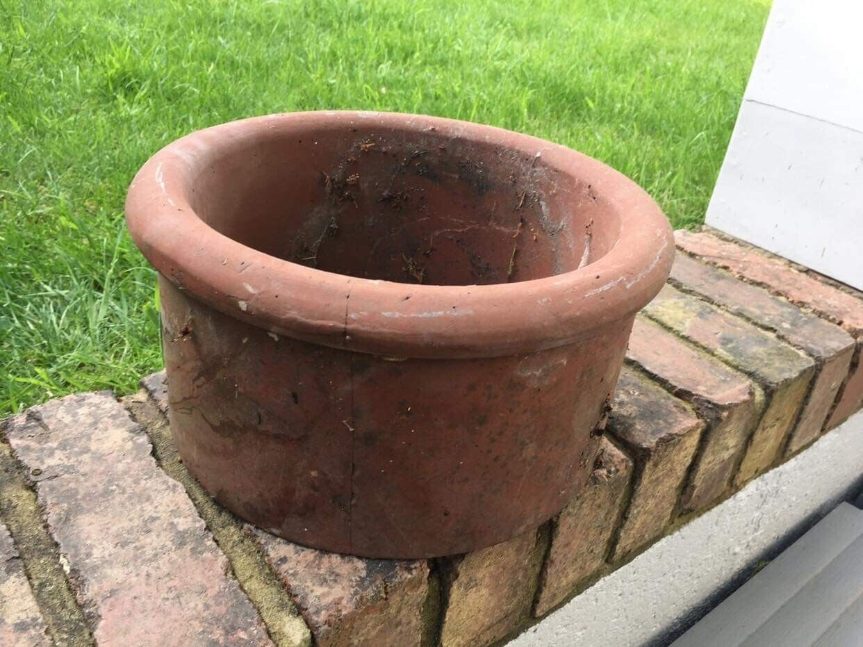 Terracotta chimney pot could be used as a planter. 29cm wide, 15cm high.