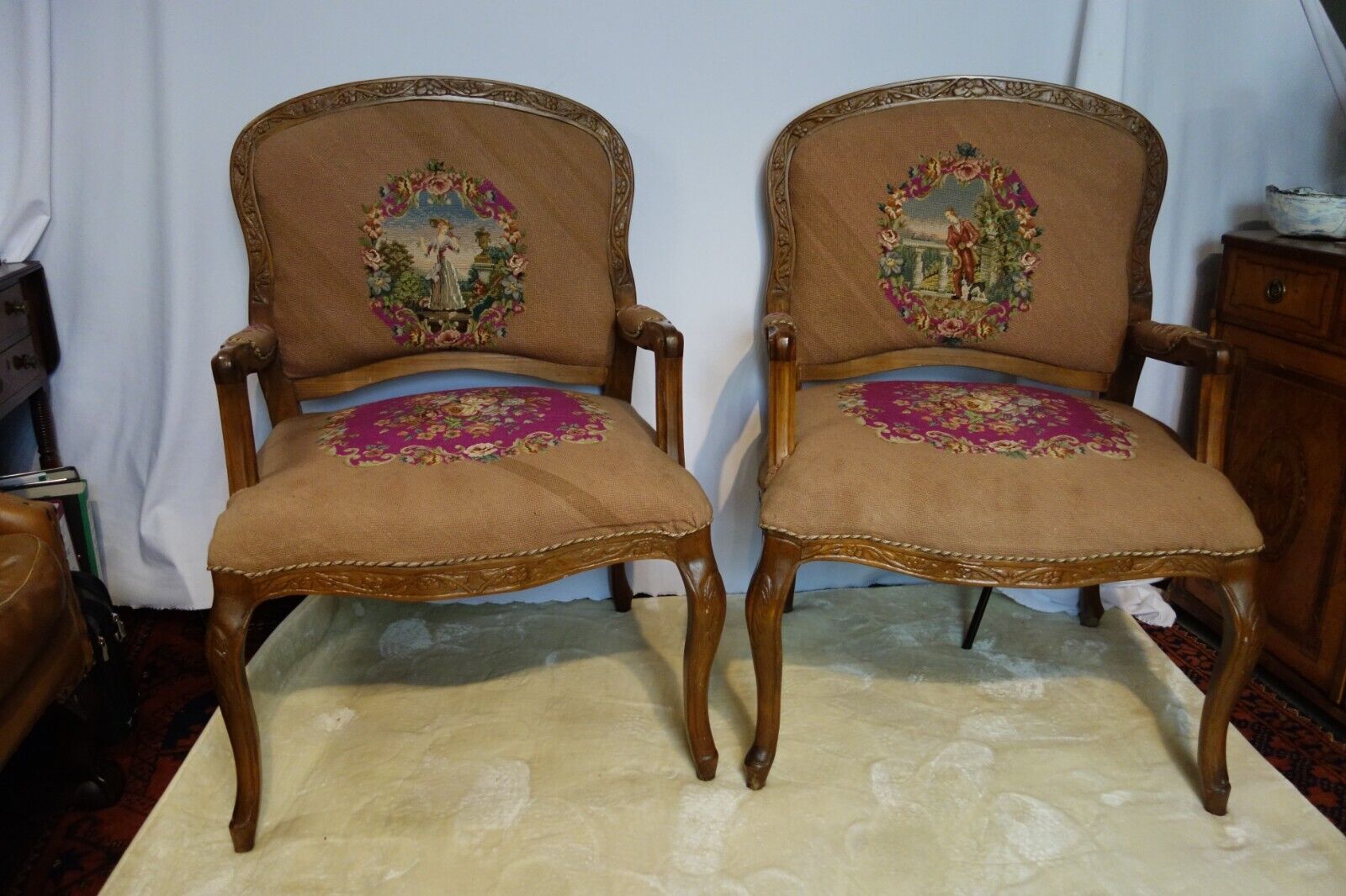 A pair of Large French walnut framed Armchairs upholstered in Tapestry