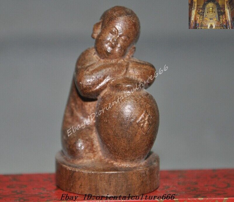 Antique Valuations: Chinese Old wood Hand-carved Boy tongzi Hold wine statue