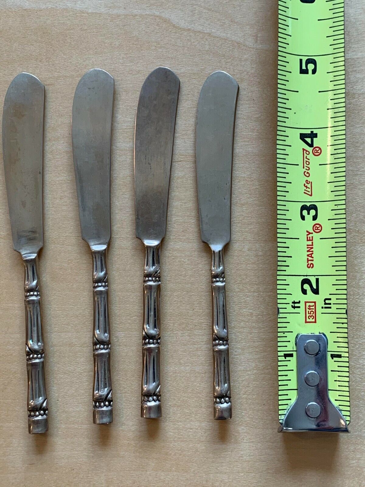 Antique Valuations: Bamboo handle brass-colored set of 4 butter spreaders, knives, vintage