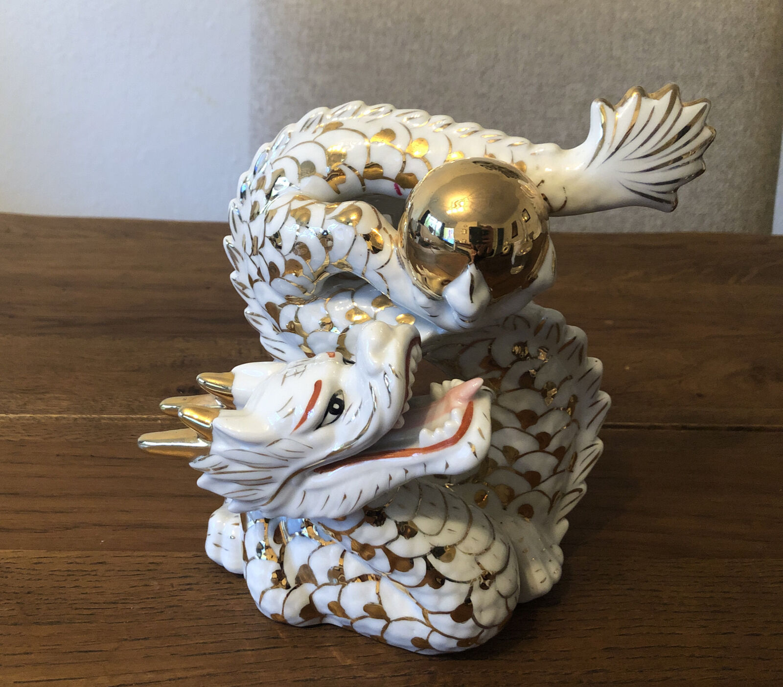Antique Valuations: Porcelain Feng Shui Dragon Holding Ball White & Gold figurine Unmarked H: 19 Cm