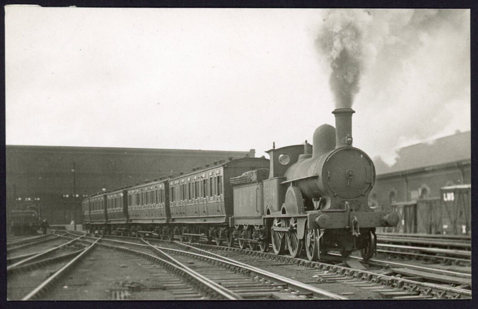 House Clearance - Railway service LMS Ex LNWR 2-4-0 No. 5104 leaving Carlisle station